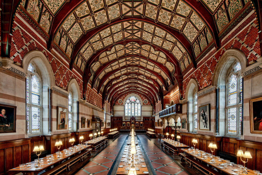The Keble College Oxford hall. It is lit beautifully and shows the stunning architecture of the heritage building.