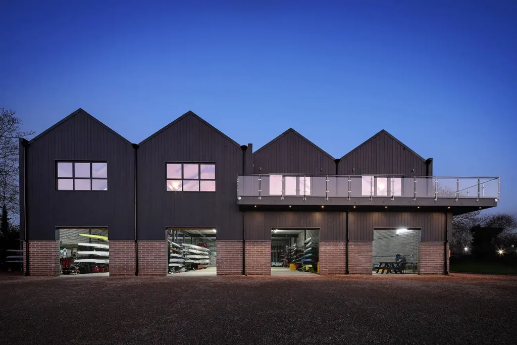 An image of the architecture of the Falcons boathouse in Oxford. It shows the pitched roofs and balconies that give a beautiful finish to the building.